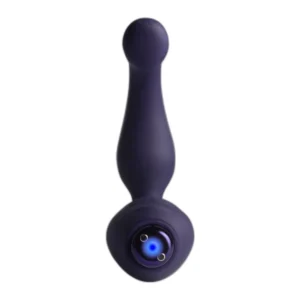 A purple silicone anal plug with a tapered shape, rounded tip, and a flared base featuring a small metallic charging port. The background is plain white.