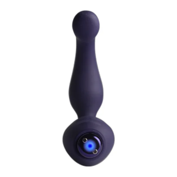 A purple silicone anal plug with a tapered shape, rounded tip, and a flared base featuring a small metallic charging port. The background is plain white.