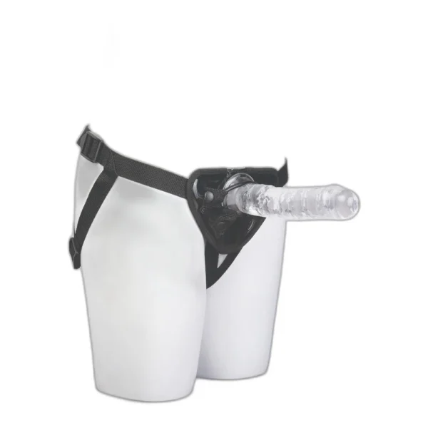 A mannequin's lower torso wearing a black strap-on harness fitted with a translucent, realistic-looking dildo, displayed against a plain white background.