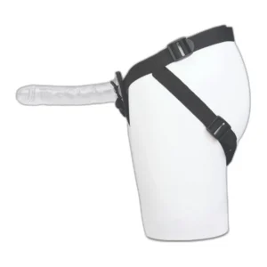 A transparent strap-on dildo attached to a black harness, shown on a white mannequin torso from the side.
