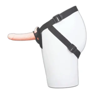 A mannequin hip model wearing a black strap-on harness with a realistic-looking dildo attached at the front.