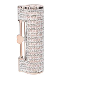 A jewelled, cylindrical lighter with rows of sparkling crystals and a pink metallic finish, featuring a small heart-shaped key detail on the side.
