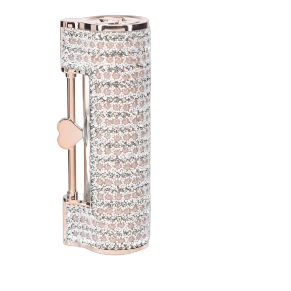 A jewelled, cylindrical lighter with rows of sparkling crystals and a pink metallic finish, featuring a small heart-shaped key detail on the side.