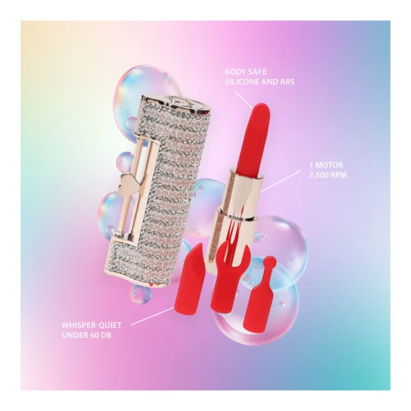 A sparkly, rhinestone-covered lipstick-shaped device with three red silicone attachments displayed on a pastel gradient background, labelled to highlight its body-safe materials, quiet motor, and 7,500 RPM speed.