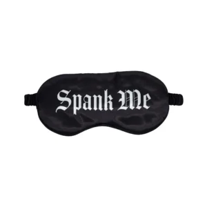 A black satin eye mask with the words "Spank Me" printed in bold, white Gothic-style letters across the front.