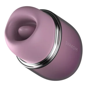 A close-up view of a purple SVAKOM branded sex toy with a smooth, oval shape and a silver metallic accent. The device has a rounded opening at one end, suggesting it is designed for external stimulation.