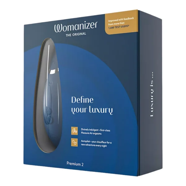 Box of Womanizer Premium 2, a luxury personal massager, shown in dark blue packaging with product image and text highlighting features and user feedback.