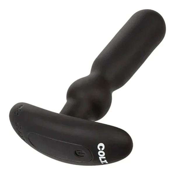 A black silicone personal massager with a handle and a flat base labelled “COLT”.