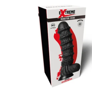 A box labelled “Extreme Monster Cocks” featuring a black, textured dildo with a suction base and a vibrating feature, shown in front of red graphics on white packaging.