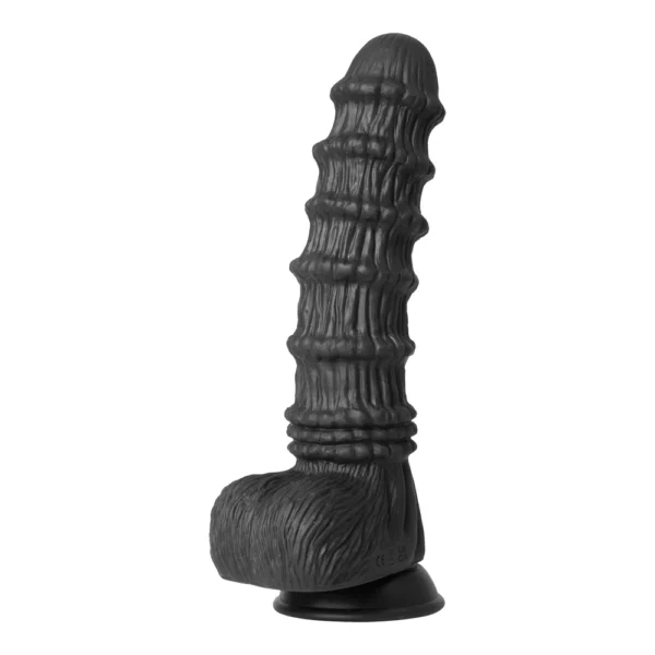 A textured, black, silicone adult novelty toy with a ribbed shaft and a base designed to resemble fur, shown upright against a white background.