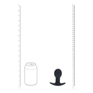 A size comparison showing a soft drink can outline next to a small, black, rounded object with a wide base, alongside rulers in inches and centimetres on each side.