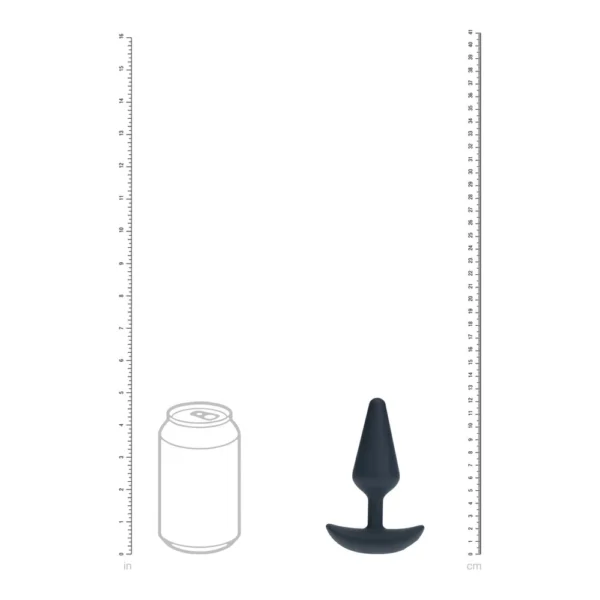 A black silicone butt plug next to the outline of a fizzy drink can, displayed between rulers showing height in inches and centimetres for size comparison.