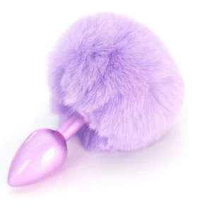 A shiny, purple metal plug with a large, fluffy, light purple faux fur ball attached to one end, displayed on a white background.