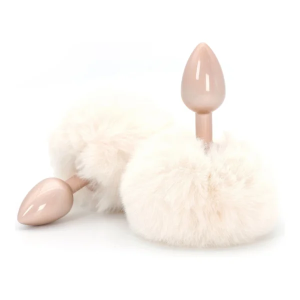 Two pink plug-shaped objects with attached fluffy white pom-poms, displayed on a white background.