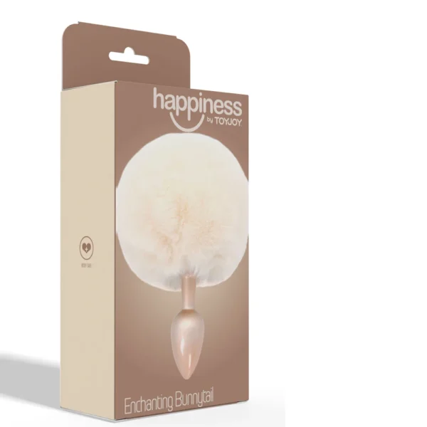 Beige box labelled “happiness by TOYJOY” displaying a fluffy, round, white faux fur bunny tail attached to a metallic plug. Text at bottom reads “Enchanting Bunnytail.” Box is upright against a white background.