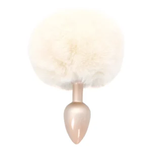 A light beige faux fur tail attached to a small, metallic, teardrop-shaped plug, photographed on a white background.