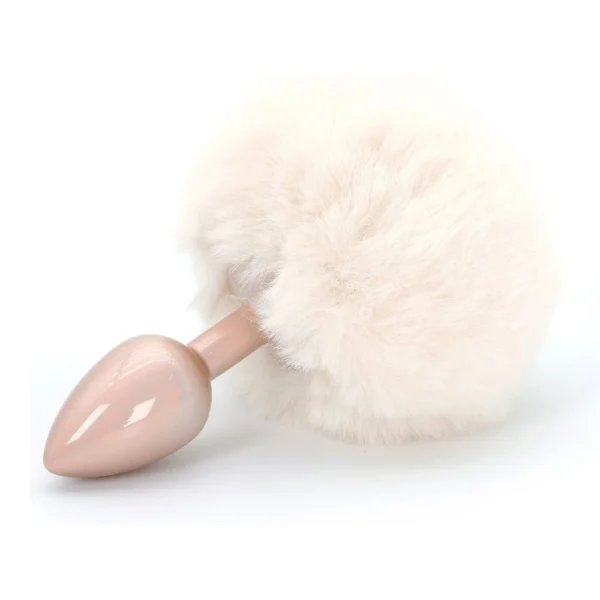 A pale pink butt plug with a large, fluffy, cream-coloured faux fur tail attached, displayed on a white background.